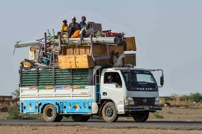 Sudanese displaced by the fighting riding with their furniture and other belongings on a truck on a road from Khartoum to Wad Madani to the south. AFP 