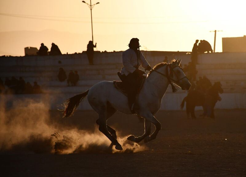 Afghan horsemen compete during a game of the traditional sport of Buzkashi, in Mazar-i-Sharif. The ancient game of Buzkashi is an Afghan national sport which is played between two teams of horsemen competing to throw a animal carcass into a circle.  AFP