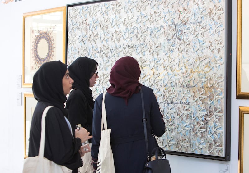 ABU DHABI, UNITED ARAB EMIRATES -Attendees looking at an artwork at the Al Burda Festival, Shaping the Future of Islamic Art and Culture at Warehouse 421, Abu Dhabi.  Leslie Pableo for The National for Melissa Gronlund’s story