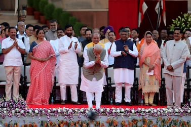 Nirmala Sitharaman, second left, stands with other members of India's cabinet as Prime Minister Narendra Modi bows during their swearing in on May 30, 2019. Bloomberg