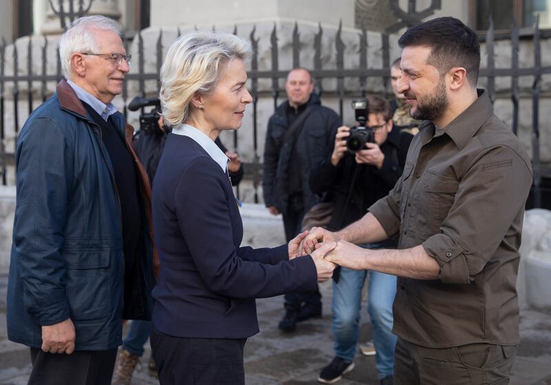 EU Commission chief Ursula von der Leyen shakes hands with Mr Zelenskyy as EU foreign affairs envoy Josep Borrell stands to her left, during their meeting in Kyiv on April 8. EPA