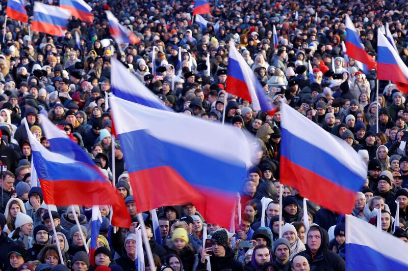 Crowds hold Russian flags at the rally and pop concert on Red Square on Monday. Reuters