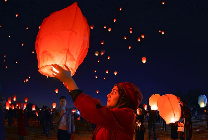 Iraqis in the holy shrine city of Najaf launch rice paper hot air balloons to show their solidarity with the ongoing anti-government protests across the country.  AFP