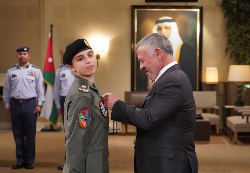 A handout picture released by the Jordanian Royal Palace on January 8, 2020 shows Jordanian King Abdullah II (R) presenting Princess Salma bint Abdullah with her wings after completing her pilot training in the capital Amman.  - RESTRICTED TO EDITORIAL USE - MANDATORY CREDIT "AFP PHOTO / JORDANIAN ROYAL PALACE / YOUSEF ALLAN" - NO MARKETING NO ADVERTISING CAMPAIGNS - DISTRIBUTED AS A SERVICE TO CLIENTS
 / AFP / Jordanian Royal Palace / Yousef ALLAN / RESTRICTED TO EDITORIAL USE - MANDATORY CREDIT "AFP PHOTO / JORDANIAN ROYAL PALACE / YOUSEF ALLAN" - NO MARKETING NO ADVERTISING CAMPAIGNS - DISTRIBUTED AS A SERVICE TO CLIENTS
