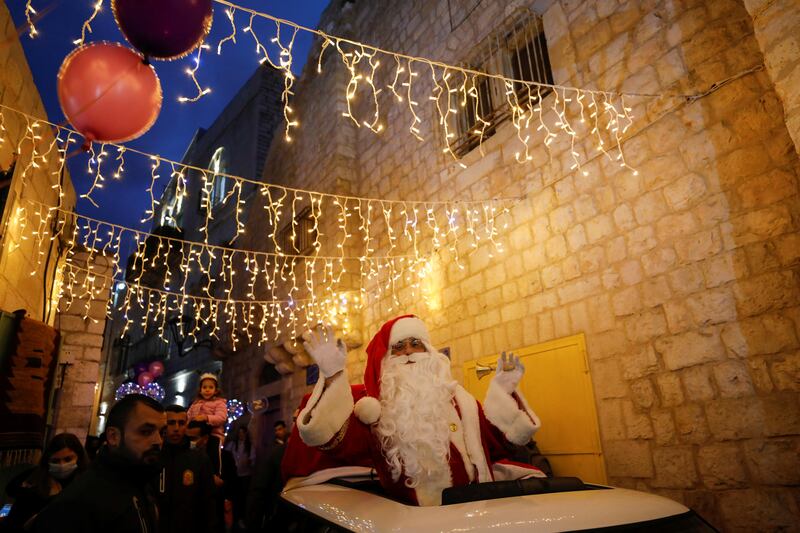 A Palestinian dressed as Santa Claus takes part in the celebrations. Reuters