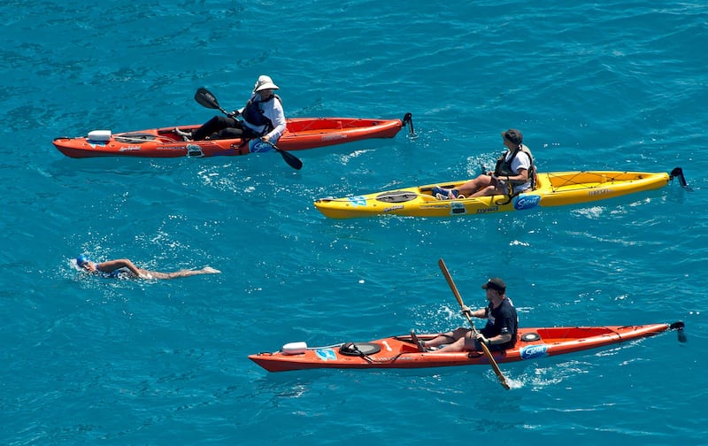 Diana Nyad, positioned about than two miles off Key West, Florida in this September 2, 2013 handout photo, is escorted by kayakers as she swims towards the completion of her 111-mile trek from Cuba to the Florida Keys. Nyad, 64, became the first swimmer to cross the Florida Straits without the security of a shark cage. REUTERS/Andy Newman/Florida Keys News Bureau/Handout   (UNITED STATES - Tags: SOCIETY SPORT) ATTENTION EDITORS - THIS IMAGE HAS BEEN SUPPLIED BY A THIRD PARTY. IT IS DISTRIBUTED, EXACTLY AS RECEIVED BY REUTERS, AS A SERVICE TO CLIENTS. FOR EDITORIAL USE ONLY. NOT FOR SALE FOR MARKETING OR ADVERTISING CAMPAIGNS *** Local Caption ***  KWP03_CUBA-SWIM-_0902_11.JPG