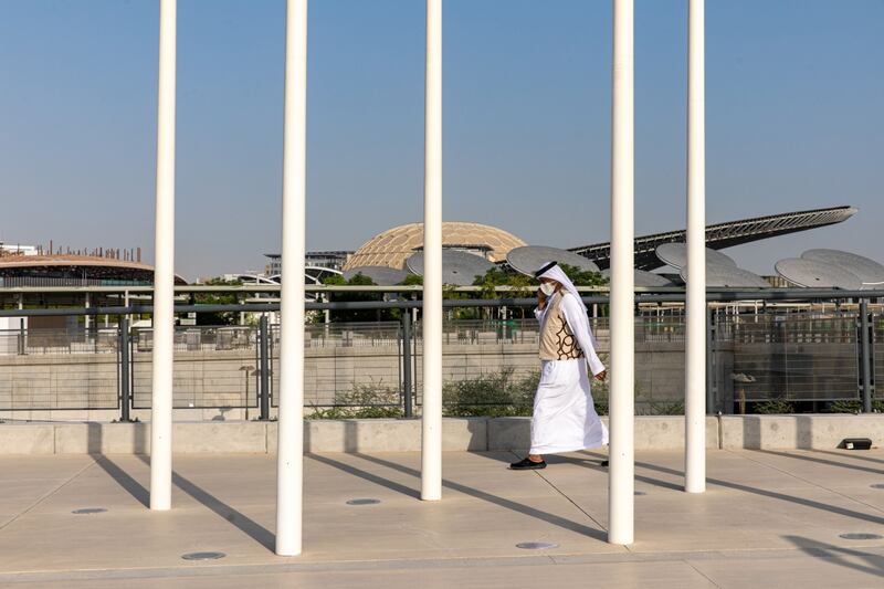 A man walks past the entrance to the Expo 2020  site in Dubai. Bloomberg