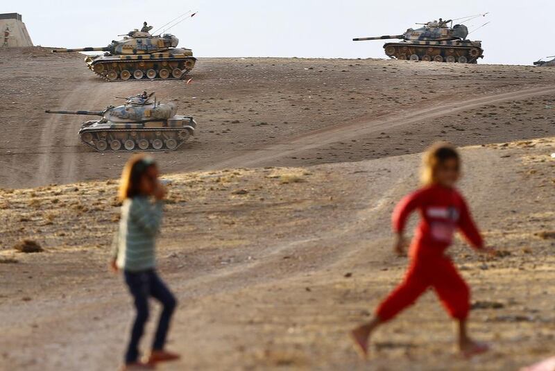 Turkish tanks guard the Syrian border after mortar shells hit Turkish territory in Suruc district, near Sanliurfa, on Monday. Sedat Suna / EPA 