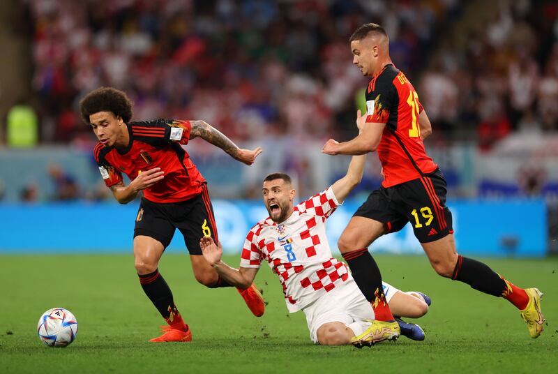 Mateo Kovacic of Croatia is challenged by Axel Witsel and Leander Dendoncker of Belgium. Getty