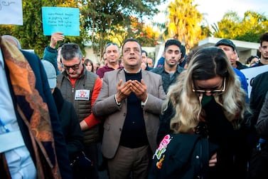 A man prays as Moroccans pay tribute to murdered Danish Louisa Vesterager Jespersen and Norwegian Maren Ueland in Rabat, in front the Norwegian embassy on December 22, 2018. AFP