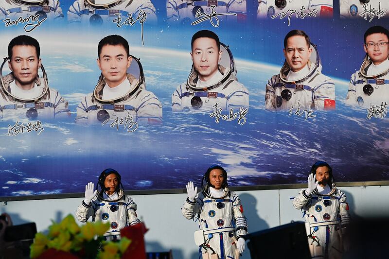 Astronauts (from left to right) Jiang Xinlin, Tang Hongbo and Tang Shengjie wave before boarding the Shenzhou-17 spacecraft which lifted off on a Long March-2F carrier rocket from Jiuquan Satellite Launch Centre in north-west China. AFP