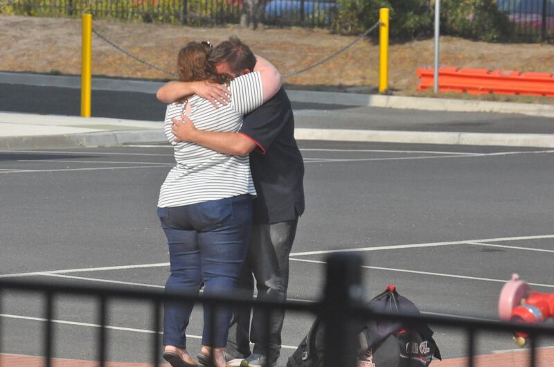 Evacuees embrace family at the Sommerville relief centre in Somervillee, Australia. Getty