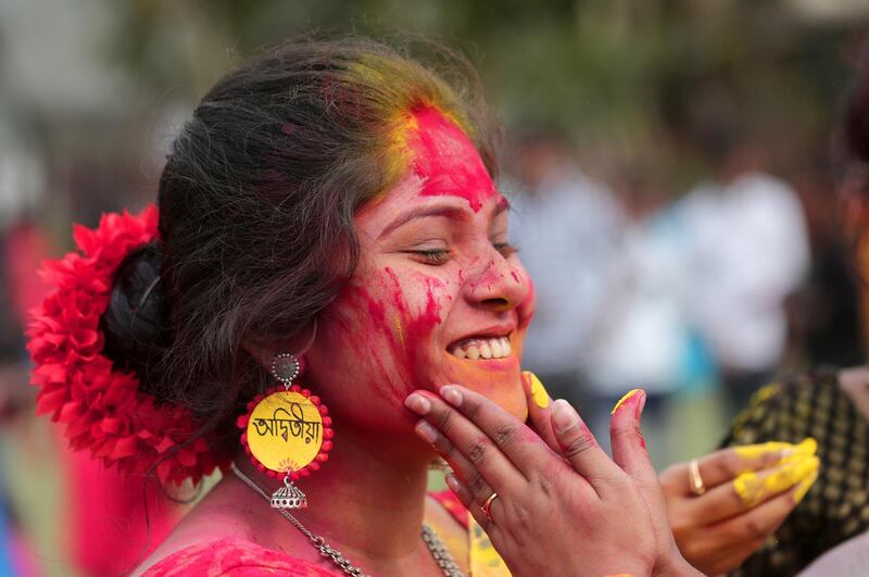 Indian students apply color on each other as they celebrate the Holi festival at Tagore University in Kolkata, Eastern India, 05 March 2020. EPA