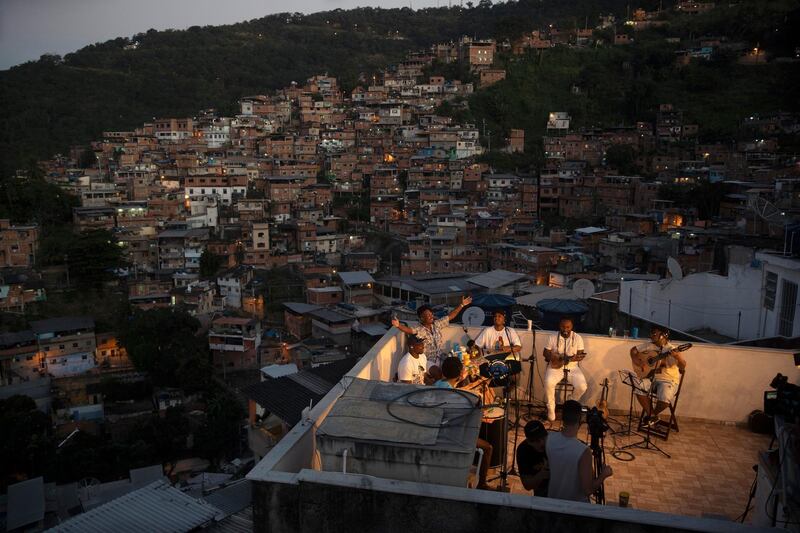 Members of the "Tempero de Criola" band perform amid the new coronavirus pandemic at the Turano favela, in Rio de Janeiro, Brazil. AP