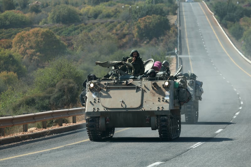 Israeli soldiers drive APCs near the border with Lebanon on Saturday. Tensions remain high at the border between the two countries. EPA