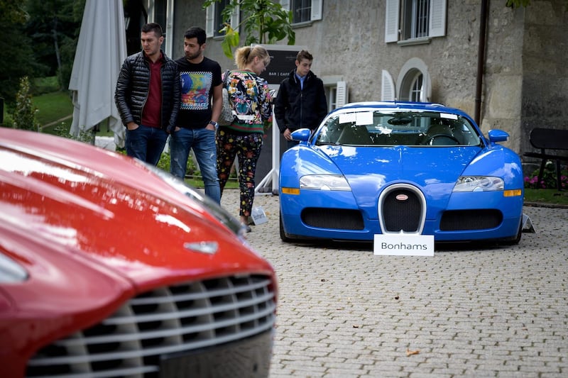 The blue Bugatti Veyron and a 2011 Aston Martin One-77 Coupe. AFP