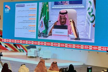 Media watches Saudi King Salman bin Abdulaziz's virtual speech during opening session of G20 Leaders' Summit in Riyadh. Reuters.