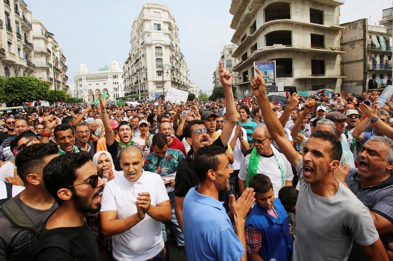 Demonstrators gesture and shout slogans during a protest rejecting Algerian election announcement for December, in Algiers, Algeria. REUTERS