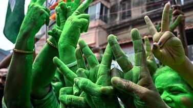 Supporters of Trinamool Congress (TMC) show victory sign as they celebrate vote counting results for India's general election outside the Chief Minister's residence in Kolkata on June 4, 2024.  India's Hindu nationalist Prime Minister Narendra Modi and his allies were heading for victory at the halfway point in the country's general election count on June 4, but with a reduced parliamentary majority.  (Photo by DIBYANGSHU SARKAR  /  AFP)