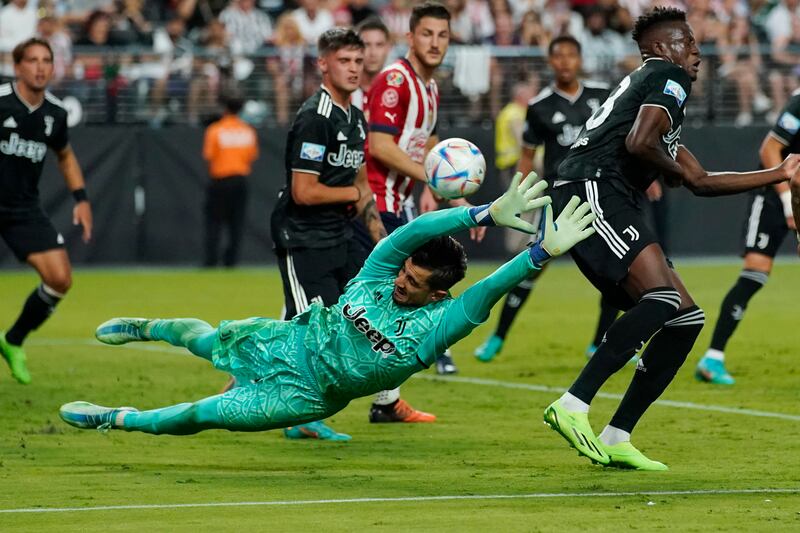 Juventus goalkeeper Mattia Perin attempts to stop a shot by Chivas. AP