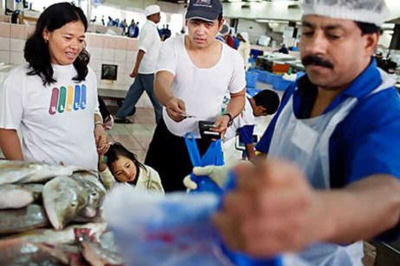 Elisabeth and Jason Tolentino, from the Philippines, haggle for the freshest fare.