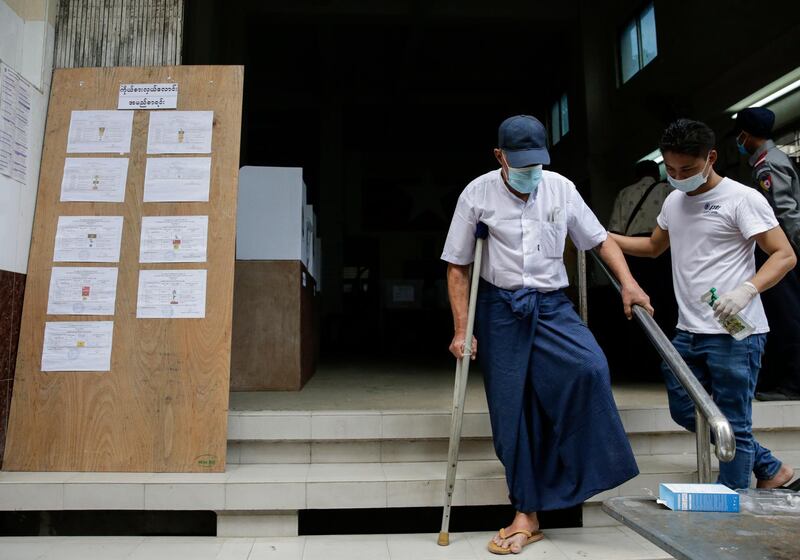 An elderly man leaves after casting his ballot in Yangon. EPA