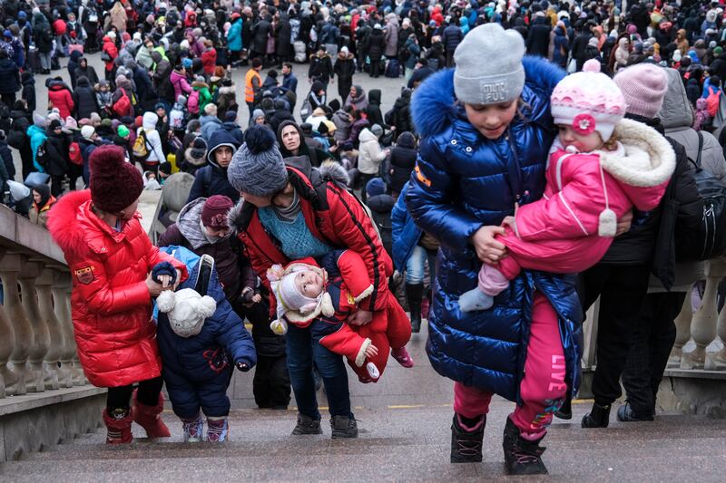 Women and children arrive at Lviv train station in western Ukraine as they try to flee the country. EPA