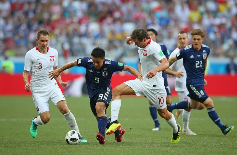 VOLGOGRAD, RUSSIA - JUNE 28:  Grzegorz Krychowiak of Poland tackles Shinji Okazaki of Japan during the 2018 FIFA World Cup Russia group H match between Japan and Poland at Volgograd Arena on June 28, 2018 in Volgograd, Russia.  (Photo by Alex Livesey/Getty Images)
