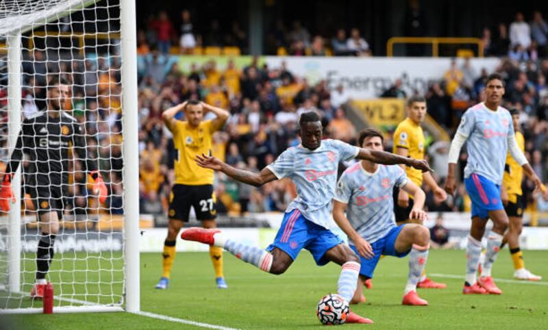 United's Aaron Wan-Bissaka clears the ball after a misssed chance by Romain Saiss of Wolves. Getty