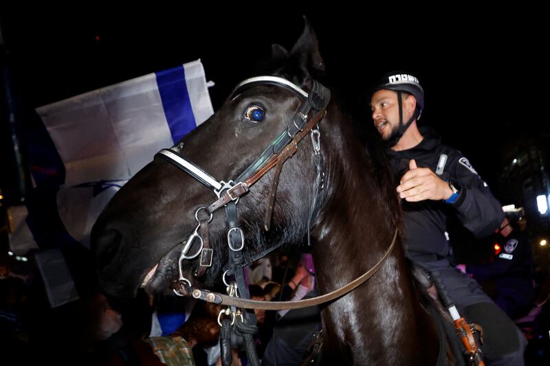 A mounted police officer gestures during a demonstration in Tel Aviv. Reuters