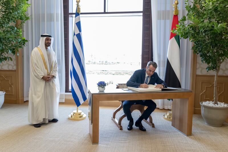 Mr Mitsotakis signed a guest book during the official reception at Qasr Al Watan.