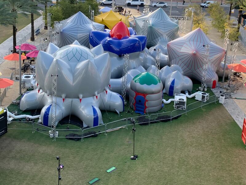 On the outside, the inflatable structure looks like a playground with its dodecahedron-inspired plastic shapes coloured in shiny silver.