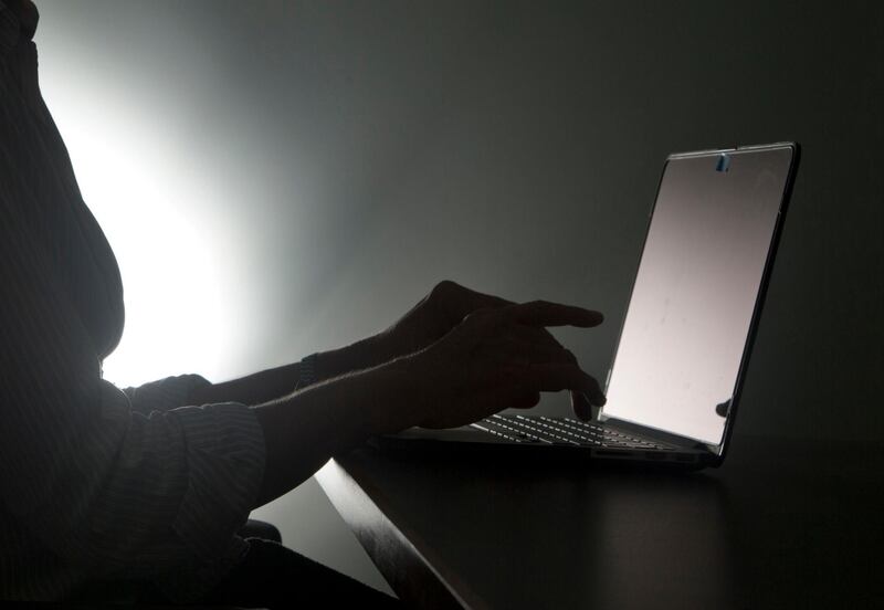 FILE - In this Dec. 12, 2016, file photo illustration, a person types on a laptop in Florida. Riviera Beach, Fla., agreed to pay $600,000 in ransom to hackers who took over its computer system, the latest in thousands of attacks worldwide aimed at extorting money from governments and businesses. Spokeswoman Rose Anne Brown said Wednesday, June 19, 2019, that the city of 35,000 residents has been working with outside security consultants, who recommended the ransom be paid. (AP Photo/Wilfredo Lee, File)