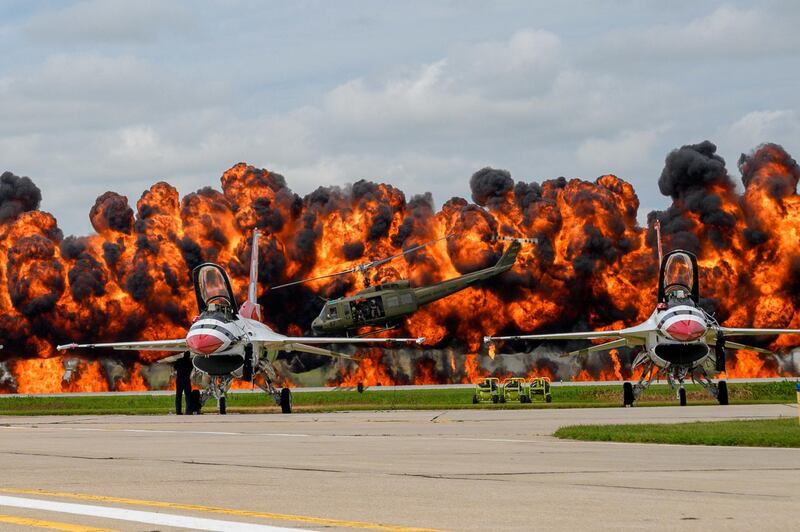 US Air Force Thunderbirds sit on the tarmac while a helicopter picks up a downed pilot amid pyrotechnics simulation during a Vietnam War reenactment at the 2019 Sioux Falls Airshow in Sioux Falls, South Dakota, US.  Reuters