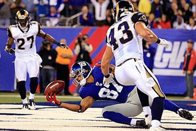 Domenik Hixon, the New York Giants wide receiver, holds on to an Eli Manning pass to score a touch down against the St Louis Rams.
