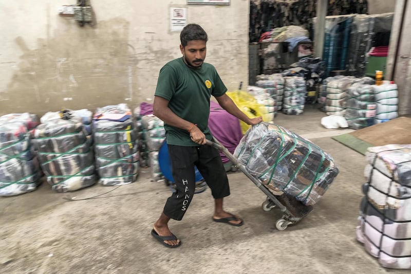 DUBAI, UNITED ARAB EMIRATES. 24 OCTOBER 2019. Second hand clothing from the UK, Australia and Europe is sported by type and quality at Hands Industries in Sharjah. Some clothes are destined to be re sold in third world markets in Africa while other damaged items are cut for use as rags in Industrial or commercial applications. (Photo: Antonie Robertson/The National) Journalist: Kelly Clarke. Section: National.
