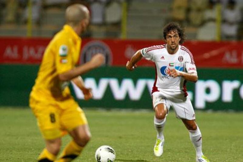 Matias Delgado, right, may have scored the winner for Al Jazira, but Al Wasl’s Mariano Donda, left, dictated the course of the match.