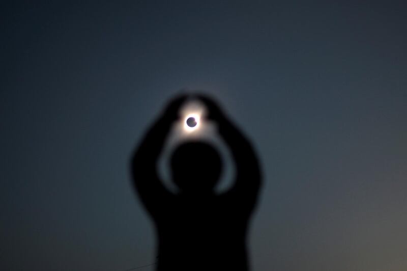 A person gestures while observing a solar eclipse at Incahuasi, Chile. Reuters
