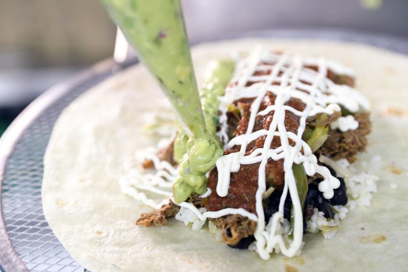 Abu Dhabi, United Arab Emirates - July 15, 2018: Owner Saied El Hakim makes a Pulled beef chuck burrito. Hidden Gems story on Burro Blanco, a new Mexican eatery in Khalidiya. Sunday, July 15th, 2018 in Burro Blanco, Abu Dhabi. Chris Whiteoak / The National