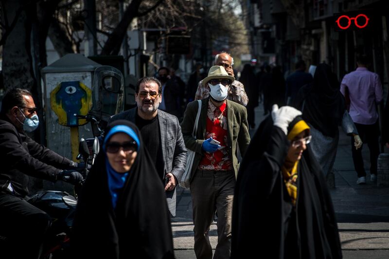 A pedestrian wears a protective face mask while walking in central Tehran, Iran. Bloomberg