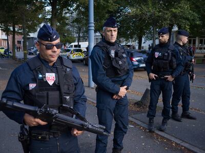 French police stand at the entrance of a school where a teacher was fatally stabbed. Getty Images