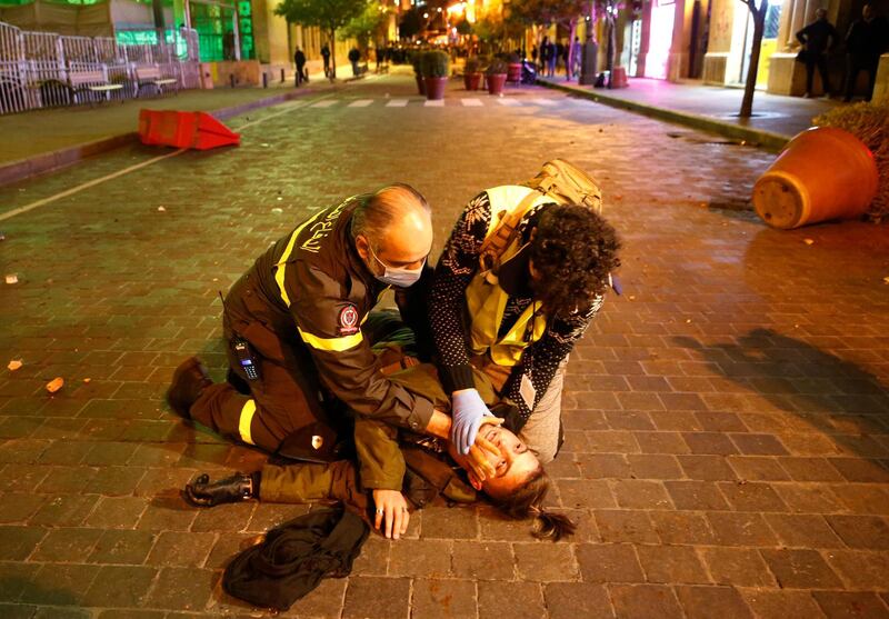 Civil defence workers treat injured protesters who were beaten by riot police. AP