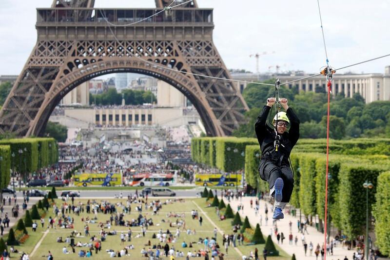 A participant rides a zip line from the second floor of the Eiffel Tower, 115 metres above the ground along an 800-metre long route, as part of a free event operating until June 11 in Paris. Charles Platiau / Reuters 