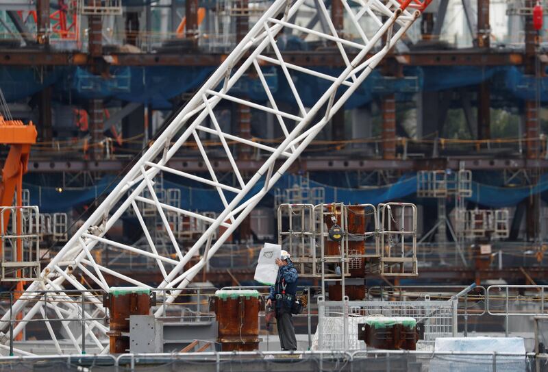 A man works at the construction site of the New National Stadium, the main stadium of Tokyo 2020 Olympics and Paralympics in Tokyo, Japan, October 13, 2017.    REUTERS/Issei Kato