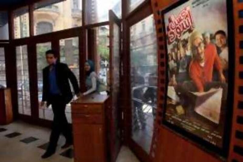 Egyptian movie fans enter a theater June 15, 2010 to see the recently released film by Egyptian comedy star Ahmed Helmy entitled "Asal Eswed" (literally translated, "Black Honey") in downtown Cairo, Egypt. The film is a social satire that tackles  issues of national identity. (Photo by Scott Nelson for the National)