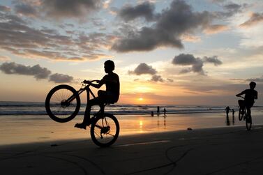 Boys play on their bicycles during sunset in Bali's Kuta district, which was the scene of a bomb attack in 2002. AP