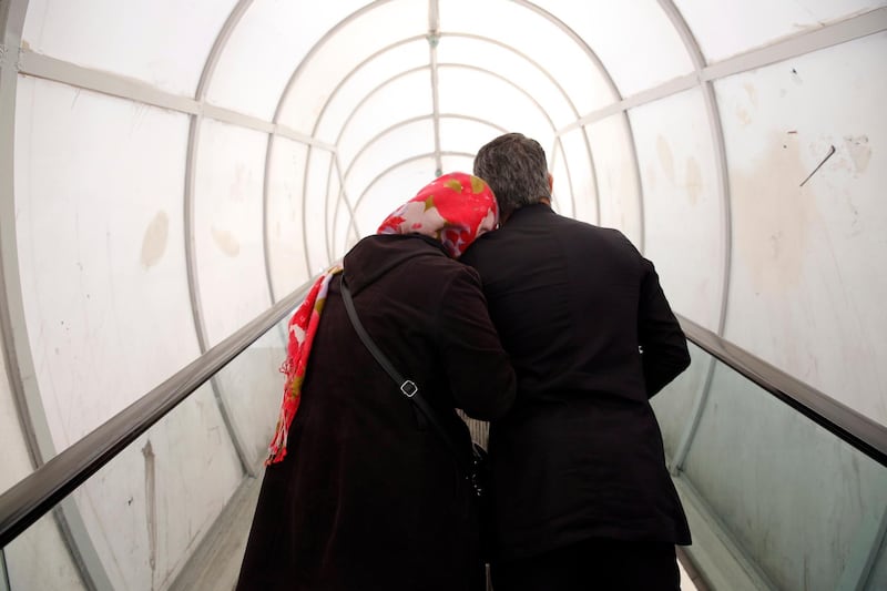 An Iranian couple use an escalator on a pedestrian bridge during coronavirus crises in Tehran, Iran. According to the last report by the Ministry of Health, 10,075 people were diagnosed with the Covid-19 coronavirus and 429 people have died in Iran.  EPA