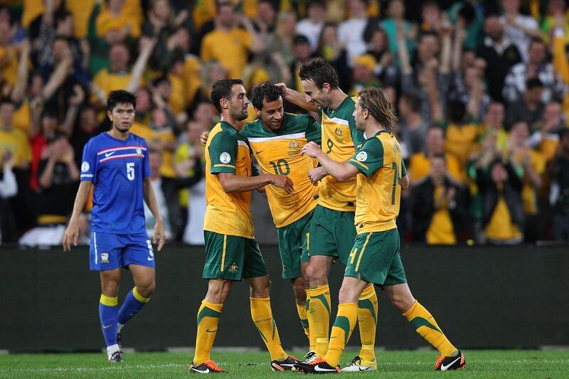 Alex Brosque, No 10, is congratulated by Australia teammates, including Brett Holman, right, after scoring against Thailand. Getty Images