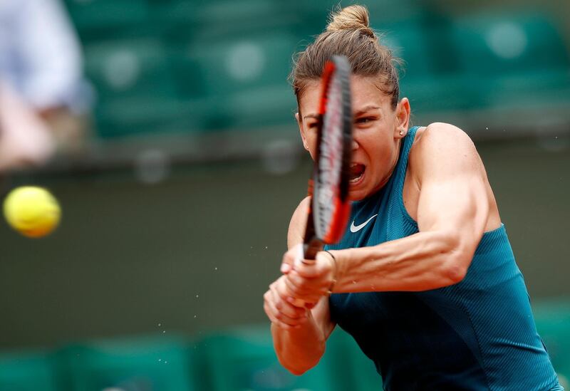 epa06772743 Simona Halep of Romania in action against Alison Riske of the USA during their women’s first round match during the French Open tennis tournament at Roland Garros in Paris, France, 30 May 2018.  EPA/YOAN VALAT