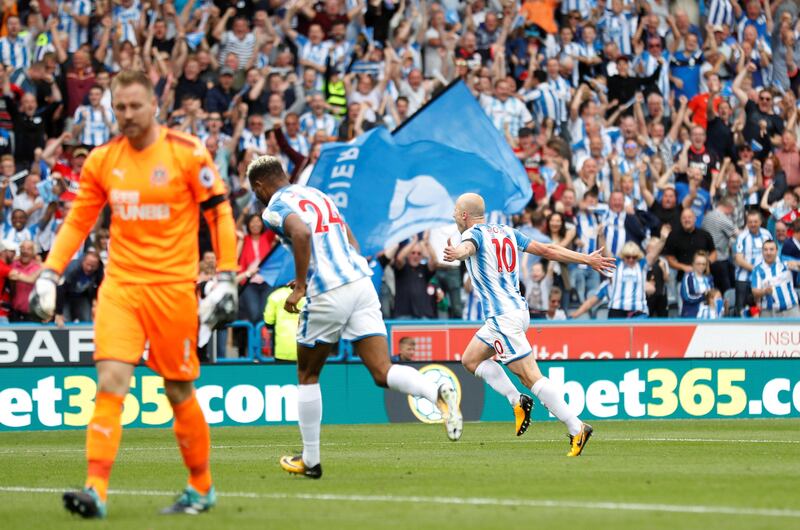 Football Soccer - Premier League - Huddersfield Town vs Newcastle United - Huddersfield, Britain - August 20, 2017   Huddersfield Town’s Aaron Mooy celebrates scoring their first goal as Newcastle United’s Robert Elliot looks dejected   Action Images via Reuters/Carl Recine    EDITORIAL USE ONLY. No use with unauthorized audio, video, data, fixture lists, club/league logos or "live" services. Online in-match use limited to 45 images, no video emulation. No use in betting, games or single club/league/player publications. Please contact your account representative for further details.